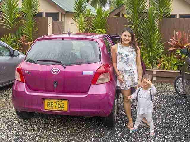 Rarotonga Getting Around by Car pink toyota car with mommy and daughter standing beside it