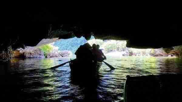 Silhouette of tourist boats under cave inside Trang An grotto
